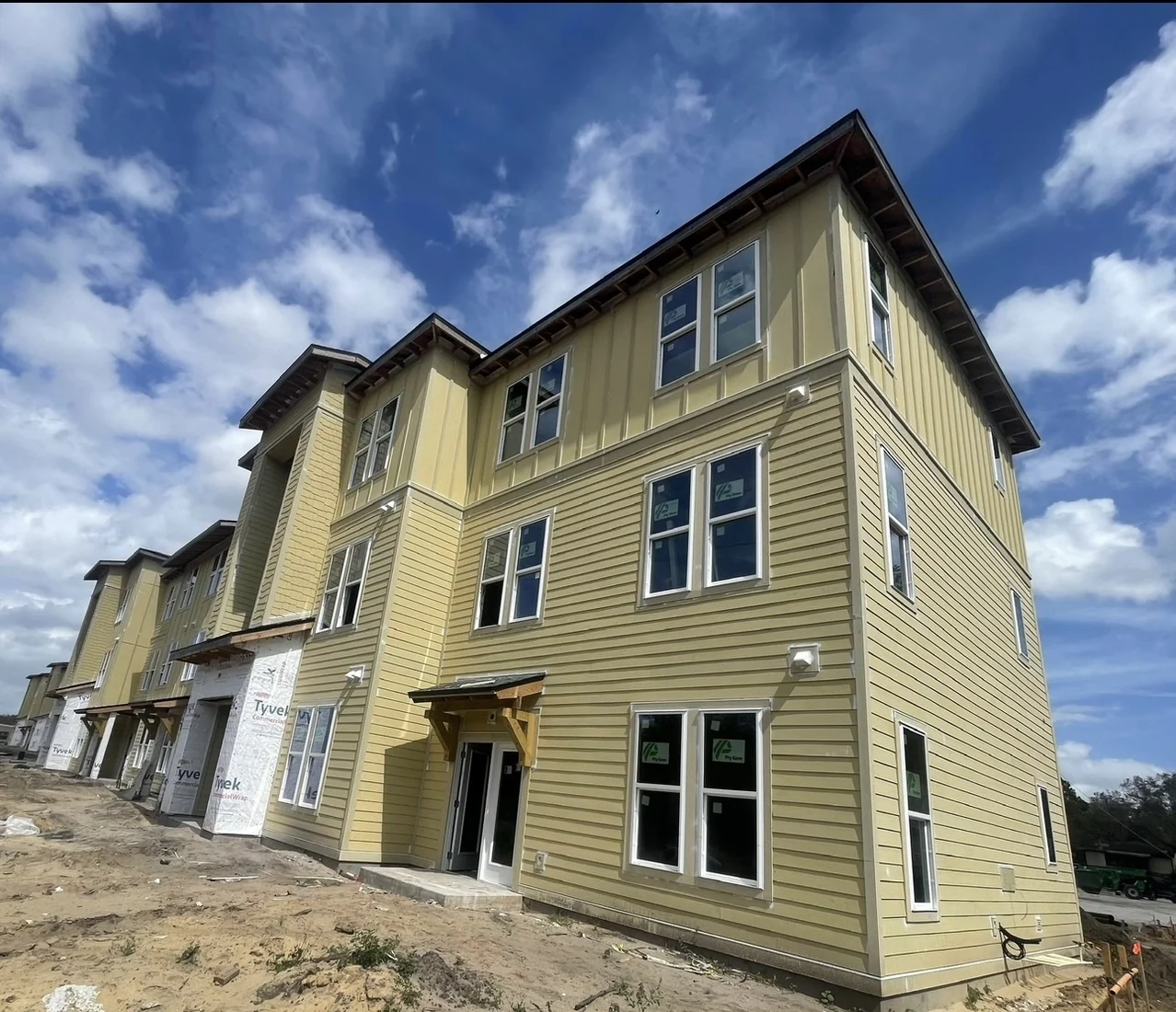 Three-story siding installation on a YBM Construction project